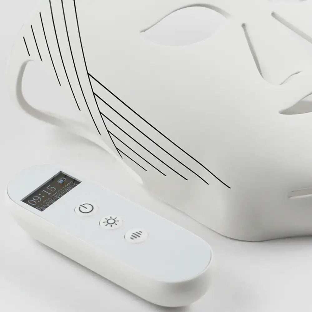 Close-up of the re-nū Liquid Silicone LED Mask and controller on a surface, unlit