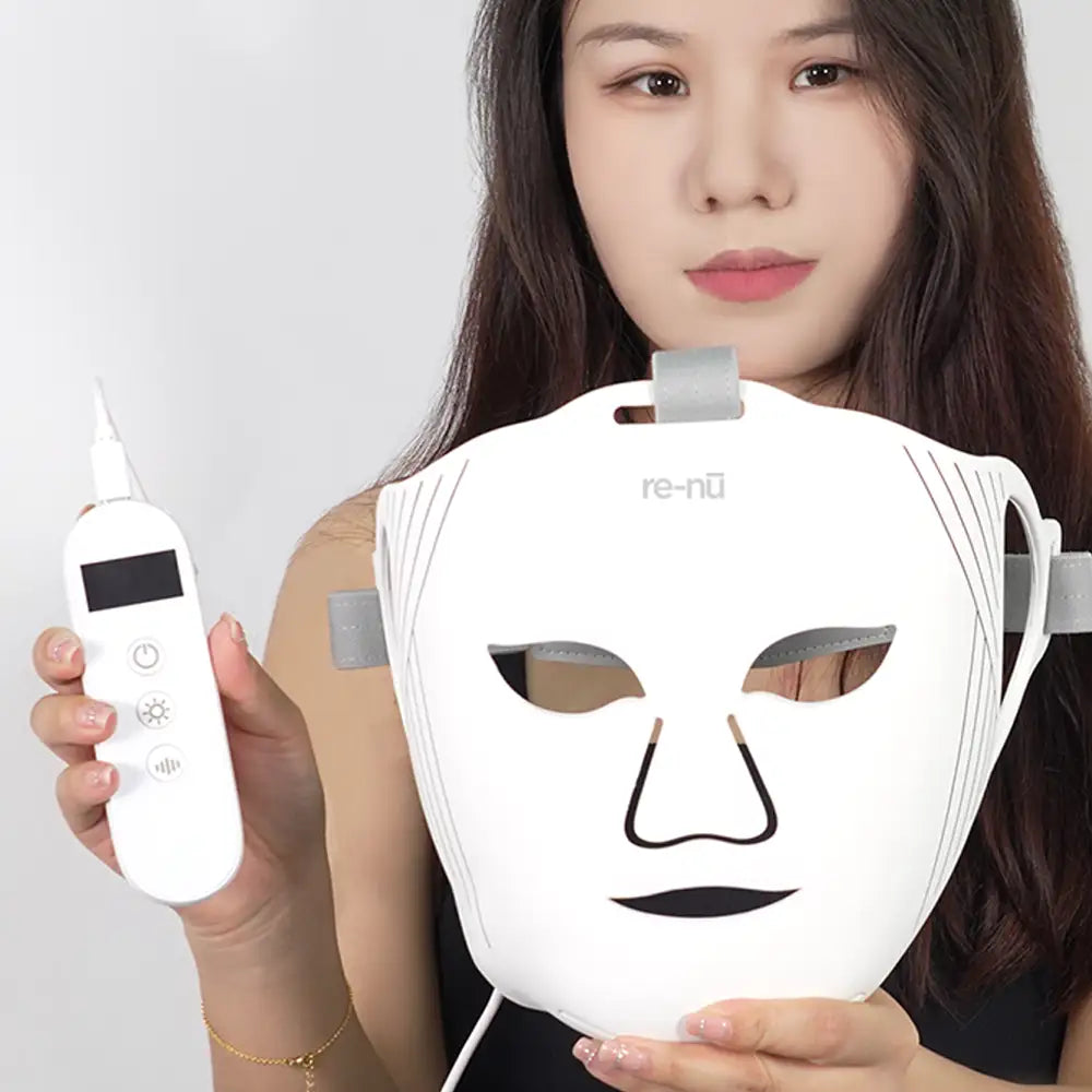 Woman holding the re-nū Liquid Silicone LED Mask and controller during setup