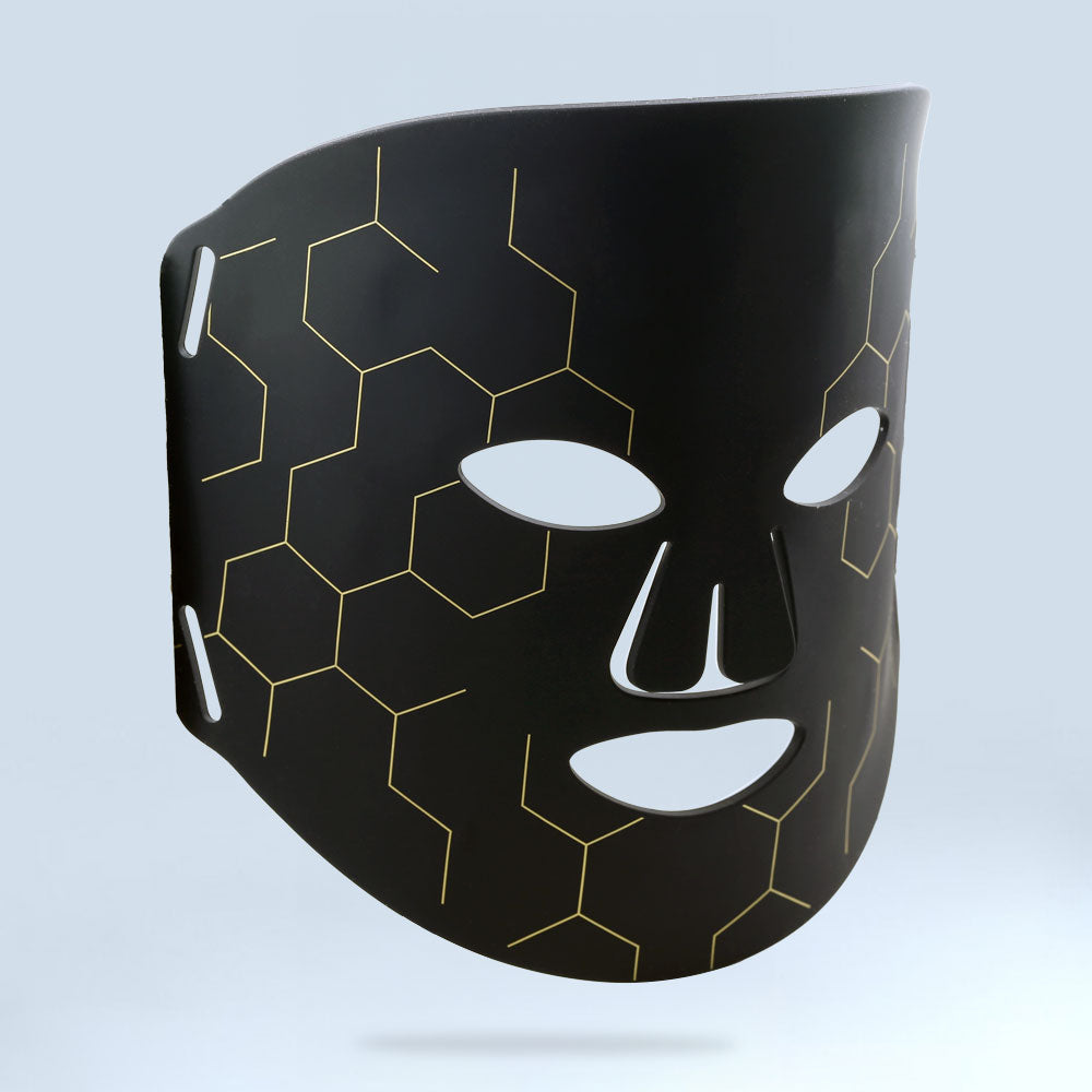 re-nū Smart Beauty Multi-Color LED Light Therapy Mask shown at a right 3/4 angle, highlighting the sleek white design and contoured fit.