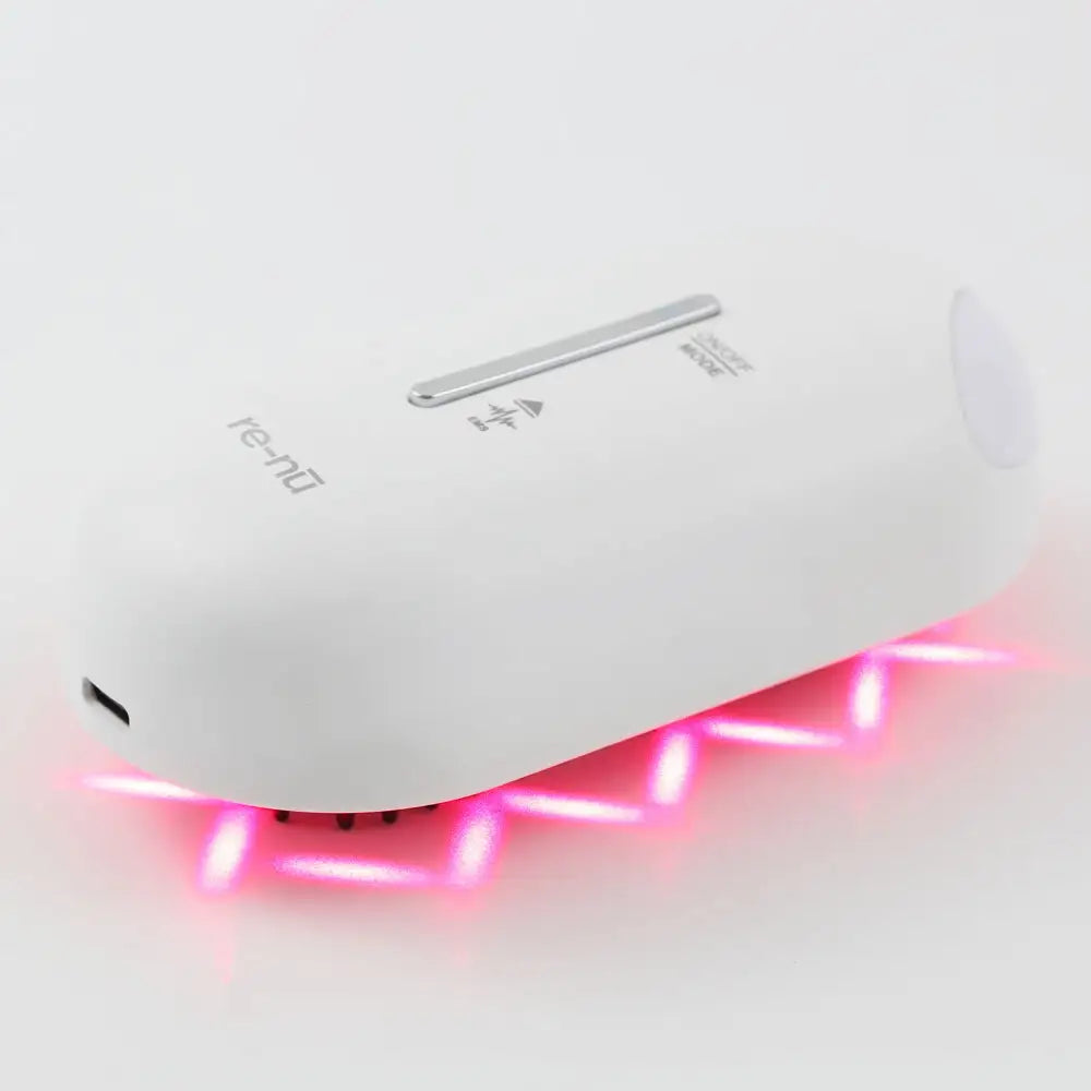 Side view of the Plasma Laser Therapy Hair Growth Comb by re-nū Smart Beauty, showing red laser reflection and easy to use EMS mode controls.