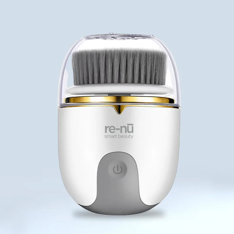 A compact white and gold facial cleansing brush with a protective cover, displayed on a soft blue background, featuring LED light therapy for advanced skincare.