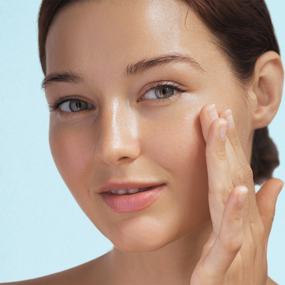 A woman with a clear complexion undergoing LED light therapy for skin rejuvenation and health.