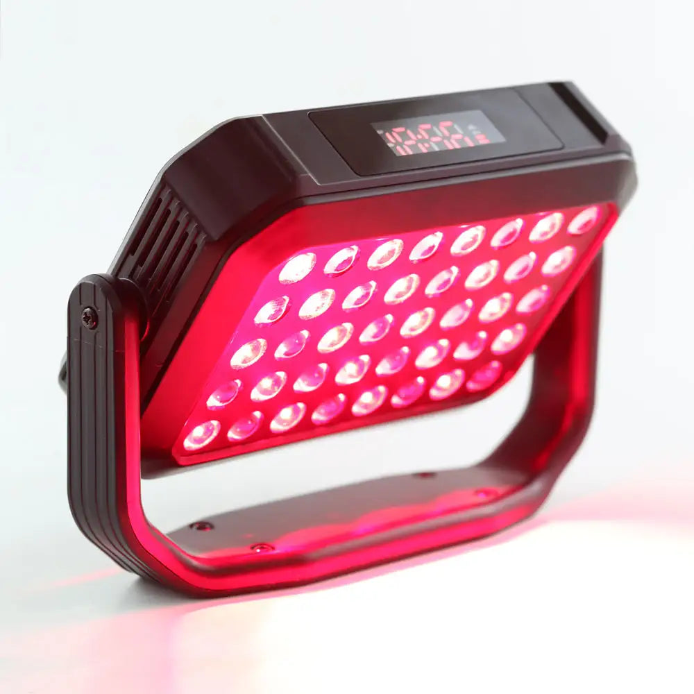 Angled view of the UltraCompact LED Red Light Therapy Panel and digital display tilted downward on its stand, emphasizing its slim, portable design and easy to read control panel display.