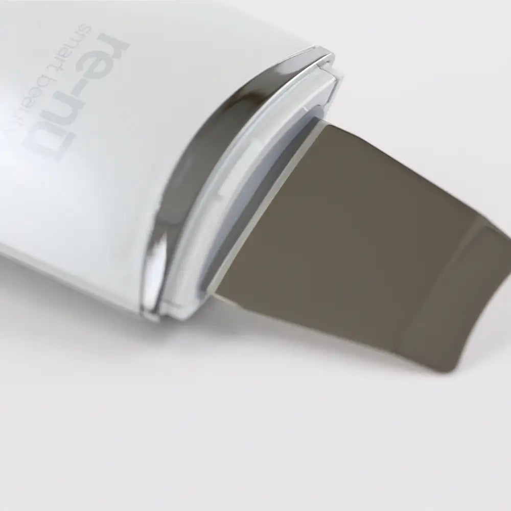 Closeup of the Ultrasonic Scrubber with Wireless Charge Base, highlighting its clean and precise ultrasonic vibrating spatula.