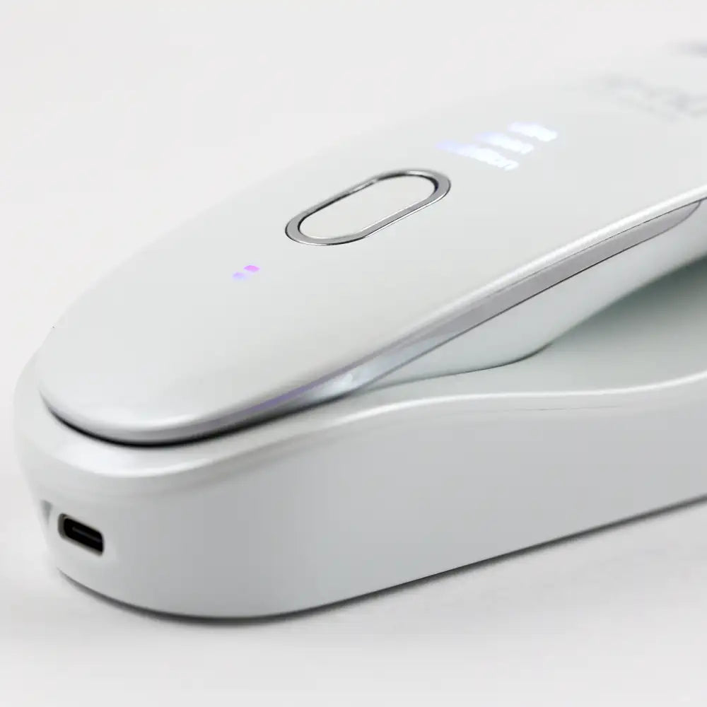 Closeup of the Ultrasonic Scrubber with Wireless Charge Base, shown resting in the charging base with USB-C port.