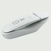 The Ultrasonic Scrubber with Wireless Charge Base, shown resting in the charging base with USB-C port.