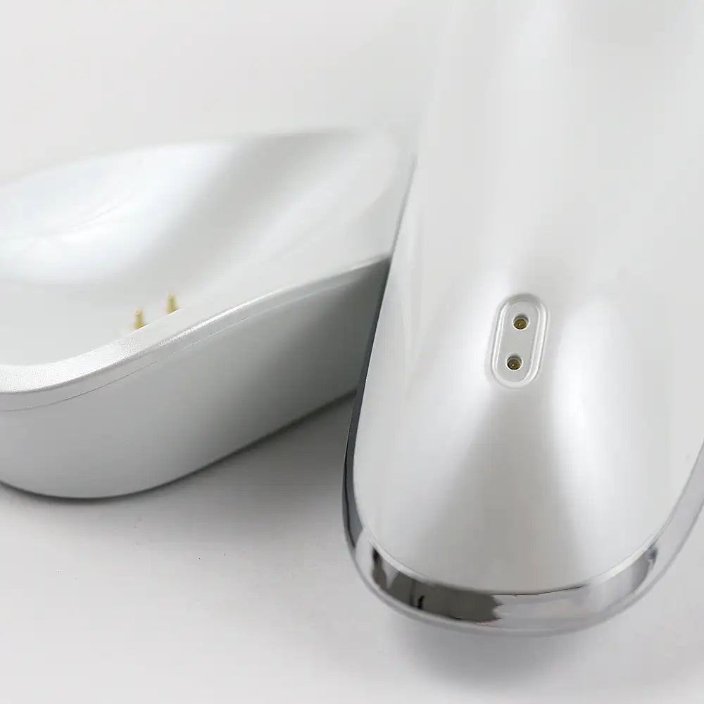 The re-nū Ultrasonic Scrubber with Wireless Charge Base, highlighting it's convenient charging and organized storage base.