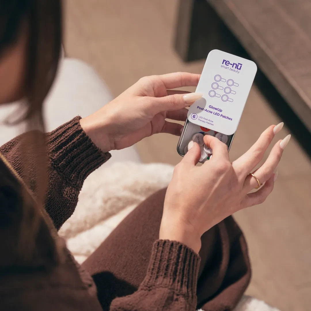 Woman opening the GlowUp Acne LED Patch packaging, preparing for at-home blue light therapy for acne treatment.